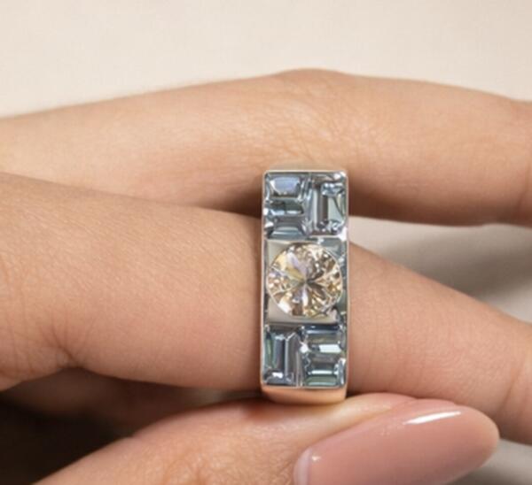 Wide gold band with aquamarine baguettes and a champagne diamond
