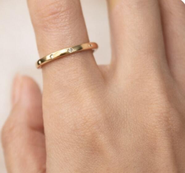 Delicate gold band with flush-set diamonds